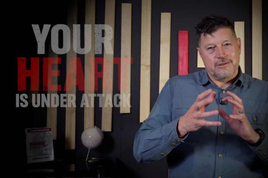 JohnDaniel Veitch discussing spiritual resilience and heart protection next to the text "Your Heart Is Under Attack," with his book Stronger in the Lord on a desk in the background.